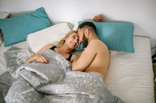 Couple smiling and talking in bed